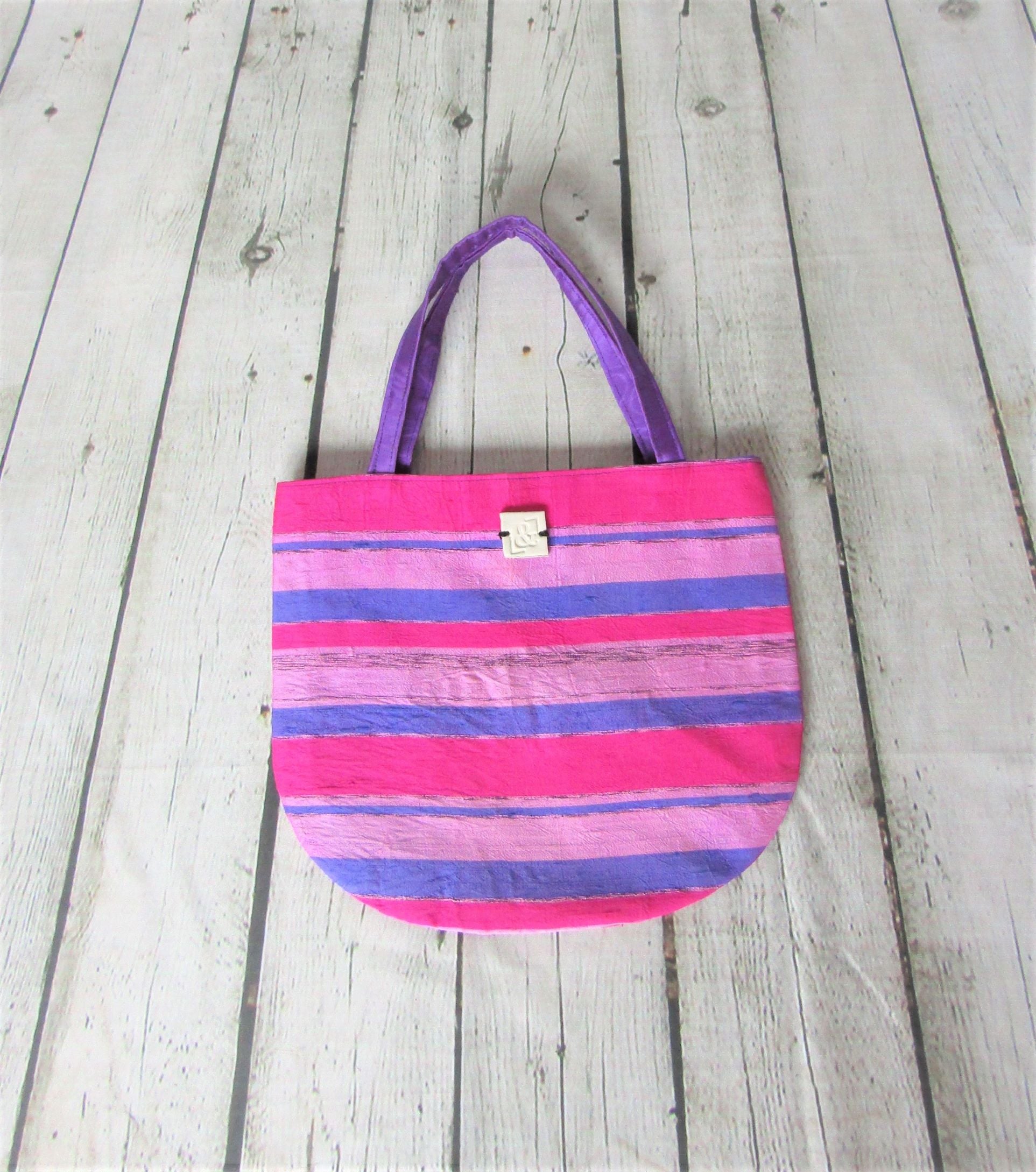Bolso de mano tonos fucsias y morados
